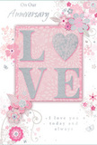 This anniversary card design radiates a sense of treasured intimacy, like a carefully chosen bouquet delivered to a familiar doorway in Mill Hill. At its heart, the word LOVE stretches confidently across the centre, each letter slightly raised and coated in ultra-fine glitter that shimmers in tones of soft blush pink and pearly white. The glitter is applied with restraint, tracing the tops and edges, creating a tactile highlight that invites touch without overwhelming the senses. The background is a serene blush-pink field, smooth and gently luminous, echoing the soft hues of pastel arrangements often requested for wedding anniversaries in the neighbourhood. Encircling this central word is a delicate composition of stylised flowers, curling vines, and slender leaves. These are rendered in fine-line illustration, with petals hinted in blush, mauve, and ivory, outlined and shaded in silver and dove grey. The floral motifs twist and spiral like airy sprays of gypsophila and eucalyptus in a hand-tied bouquet, drifting outwards with a feeling of light motion, as though a gentle breeze from Mill Hill Park had ruffled them into place. Tiny accents-small petals, swirling tendrils, and discreet butterflies-are touched with glitter and subtle metallic sheen, bringing a sense of playful romance. The text On Our Anniversary and a loving declaration such as I love you today and always appear in graceful script, their flowing lines echoing the curves of the floral decoration. Overall, the image conveys a calm, affectionate atmosphere, a paper keepsake that mirrors the softness of an English spring garden and pairs beautifully with fresh anniversary flowers delivered across Mill Hill.